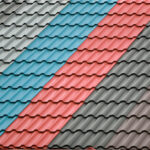 Architectural background. Texture of a metal roof tiles of black, blue and red colors.