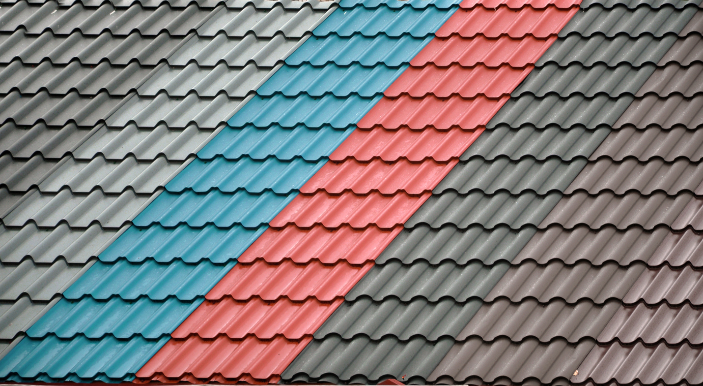 Architectural background. Texture of a metal roof tiles of black, blue and red colors.