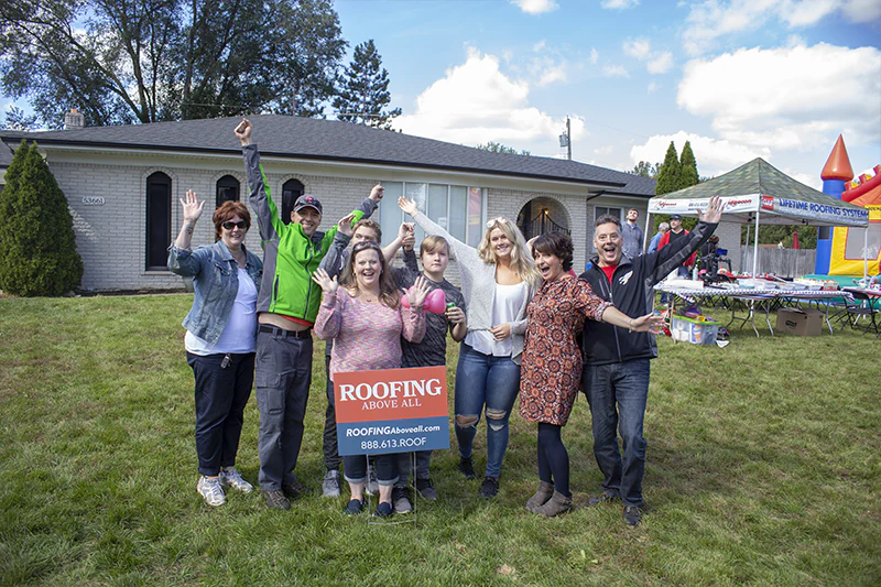 familiy with a new roof celebrating