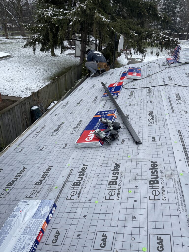 Guy on roof in winter time