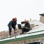 roofing contractors are repairing roof in winter time