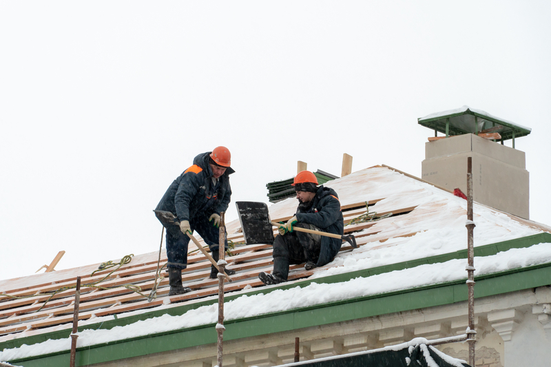 roofing contractors are repairing roof in winter time