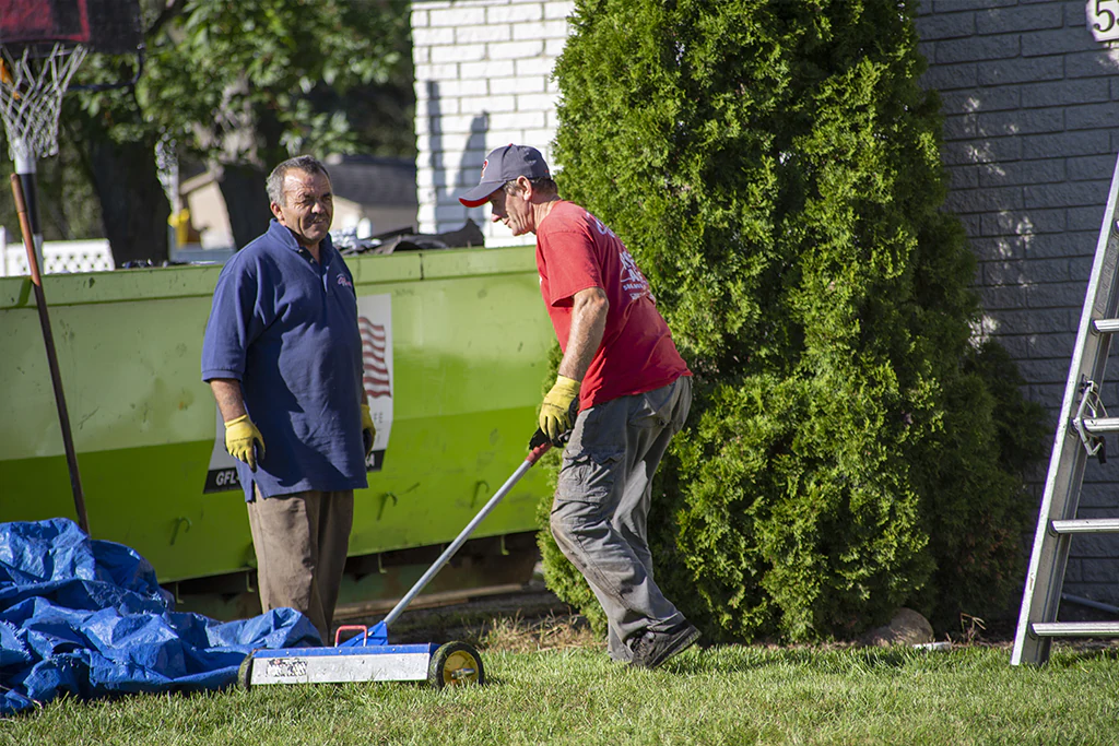 roofers cleaning behind