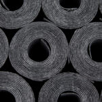 Rolls of roof coating. Rolls of new black roof coating or bitumen. Front view roofing felt